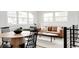Bright living room featuring a leather couch, many windows, and an open floor plan at 1617 S Quitman St, Denver, CO 80219