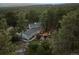 Aerial shot of a secluded mountain home nestled in a tranquil, wooded setting at 18971 Shadowood Dr, Monument, CO 80132