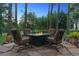 Comfortable outdoor seating around fire pit on the stone backyard patio at 18971 Shadowood Dr, Monument, CO 80132