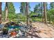 Lush backyard landscape featuring a water feature, stone patio and seating at 18971 Shadowood Dr, Monument, CO 80132