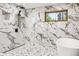 Stunning primary bathroom featuring marble-style tiles and a window view at 18971 Shadowood Dr, Monument, CO 80132