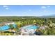 Gorgeous aerial view of a community pool surrounded by beautiful green landscape, clubhouse and other facilities at 18971 Shadowood Dr, Monument, CO 80132
