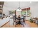 Bright dining area with wood floors, a round table, and a view of the outdoor space through sliding glass doors at 18971 Shadowood Dr, Monument, CO 80132