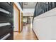 Inviting foyer showcasing hardwood floors, a staircase with dark railings, and an open view into the living room at 18971 Shadowood Dr, Monument, CO 80132