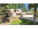 Beautiful home exterior featuring lush landscaping and an attached garage at 18971 Shadowood Dr, Monument, CO 80132