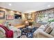 Comfortable living room featuring neutral sofas, a floral rug, a large window, and recessed lighting at 18971 Shadowood Dr, Monument, CO 80132