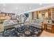 Spacious living room features hardwood floors and built-in wet bar at 18971 Shadowood Dr, Monument, CO 80132