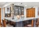 Basement bar area with a marble countertop, seating, and storage cabinets at 18971 Shadowood Dr, Monument, CO 80132