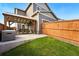Backyard patio with a pergola, hot tub, and a wooden fence at 6833 Longpark Dr, Parker, CO 80138