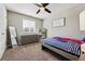 Bright bedroom with a ceiling fan, large dresser, white board, and twin bed at 6833 Longpark Dr, Parker, CO 80138