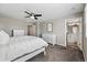 Spacious bedroom with a ceiling fan, plush carpet, and an en-suite bathroom at 6833 Longpark Dr, Parker, CO 80138