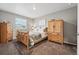 Cozy bedroom featuring a wooden bed frame, dresser, and armoire at 6833 Longpark Dr, Parker, CO 80138