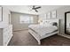 Bedroom featuring neutral walls, a ceiling fan, large windows, and a white comforter at 6833 Longpark Dr, Parker, CO 80138
