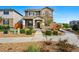 Charming two-story home features a stone facade, covered porch, and well-manicured landscaping at 6833 Longpark Dr, Parker, CO 80138