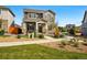 Beautiful two-story house with a stone and siding exterior, walkway, and meticulous landscaping at 6833 Longpark Dr, Parker, CO 80138