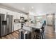 Bright kitchen featuring stainless steel appliances, granite countertops, and an island with barstool seating at 6833 Longpark Dr, Parker, CO 80138