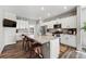 Modern kitchen features white cabinets, granite countertops, stainless steel appliances, and a large island at 6833 Longpark Dr, Parker, CO 80138