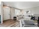 Inviting living room with a large sectional sofa, sleek decor, and modern flooring at 6833 Longpark Dr, Parker, CO 80138