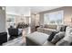 Open-concept living room showcases a dining area, comfortable seating, and ample natural light at 6833 Longpark Dr, Parker, CO 80138