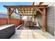 Backyard patio with a pergola, hot tub, table and chairs, and grill at 6833 Longpark Dr, Parker, CO 80138
