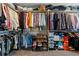 Spacious walk-in closet with ample storage, shelves, hanging rods, and organizers at 6833 Longpark Dr, Parker, CO 80138