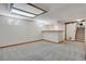 Finished basement area with carpet, a stylish bar area with a wooden countertop, and stairs leading to another level at 9386 W Geddes Pl, Littleton, CO 80128