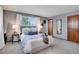 Cozy bedroom featuring soft carpet, gray walls, and a large window with natural light and tastefully appointed decor at 9386 W Geddes Pl, Littleton, CO 80128