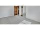 Spacious bedroom with soft carpet, fresh white walls, closet with mirrored door, and a paneled wooden door at 9386 W Geddes Pl, Littleton, CO 80128