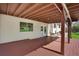 A charming deck with a painted wood floor and string lights for outdoor enjoyment at 9386 W Geddes Pl, Littleton, CO 80128