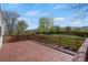 Spacious wooden deck with natural landscaping views in the background at 9386 W Geddes Pl, Littleton, CO 80128