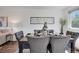 Dining area featuring a gray table with seating for six, art, and modern decor at 9386 W Geddes Pl, Littleton, CO 80128