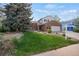 Beautiful two-story home with landscaped yard, brick details, and a spacious driveway at 9386 W Geddes Pl, Littleton, CO 80128