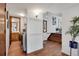 Hallway featuring hardwood floors and access to the laundry room, bathroom, and stairs at 9386 W Geddes Pl, Littleton, CO 80128