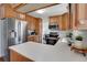 Bright kitchen with stainless steel fridge, white countertops, and wood cabinets at 9386 W Geddes Pl, Littleton, CO 80128