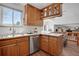 Kitchen area with wood cabinets, stainless steel appliances, and open sight lines at 9386 W Geddes Pl, Littleton, CO 80128