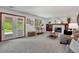 Bright living room featuring a fireplace and access to the outdoors through double doors at 9386 W Geddes Pl, Littleton, CO 80128