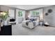 Serene bedroom with neutral colors, carpeted floor, and natural light from two large windows at 9386 W Geddes Pl, Littleton, CO 80128