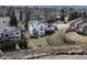 Aerial view of a home with large windows and a deck, nestled in a neighborhood with mature trees at 353 Columbine Ave, Broomfield, CO 80020