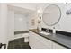 A modern bathroom features a sleek vanity, stylish mirror, and walk-in shower at 353 Columbine Ave, Broomfield, CO 80020