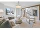 Open-concept living room featuring comfortable seating, stylish decor, and a staircase in the background at 353 Columbine Ave, Broomfield, CO 80020