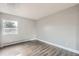 An empty, sun-drenched bedroom with hardwood floors and a single window at 451 Golden Cir # 210, Golden, CO 80401