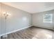 An empty bedroom featuring hardwood floors, a window, and modern lighting at 451 Golden Cir # 210, Golden, CO 80401