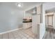 Well-lit kitchen with white cabinets, black countertops, and tiled flooring at 451 Golden Cir # 210, Golden, CO 80401