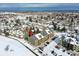 Aerial view showing townhome complex in snowy landscape at 10872 W Evans Ave # 2E, Lakewood, CO 80227