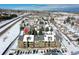 Aerial view of townhome community with snow and mountain views at 10872 W Evans Ave # 2E, Lakewood, CO 80227