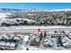 Aerial view of townhome, snow-covered landscape, and mountains at 10872 W Evans Ave # 2E, Lakewood, CO 80227