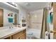 Updated bathroom with bathtub, shower, and vanity with storage at 10872 W Evans Ave # 2E, Lakewood, CO 80227