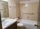 Bathroom with a bathtub, toilet, sink, and vanity with tile and hardware at 10872 W Evans Ave # 2E, Lakewood, CO 80227