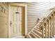 Apartment entry with a door and wooden staircase at 10872 W Evans Ave # 2E, Lakewood, CO 80227