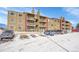 Exterior view of the building showing parking and landscaping at 10872 W Evans Ave # 2E, Lakewood, CO 80227